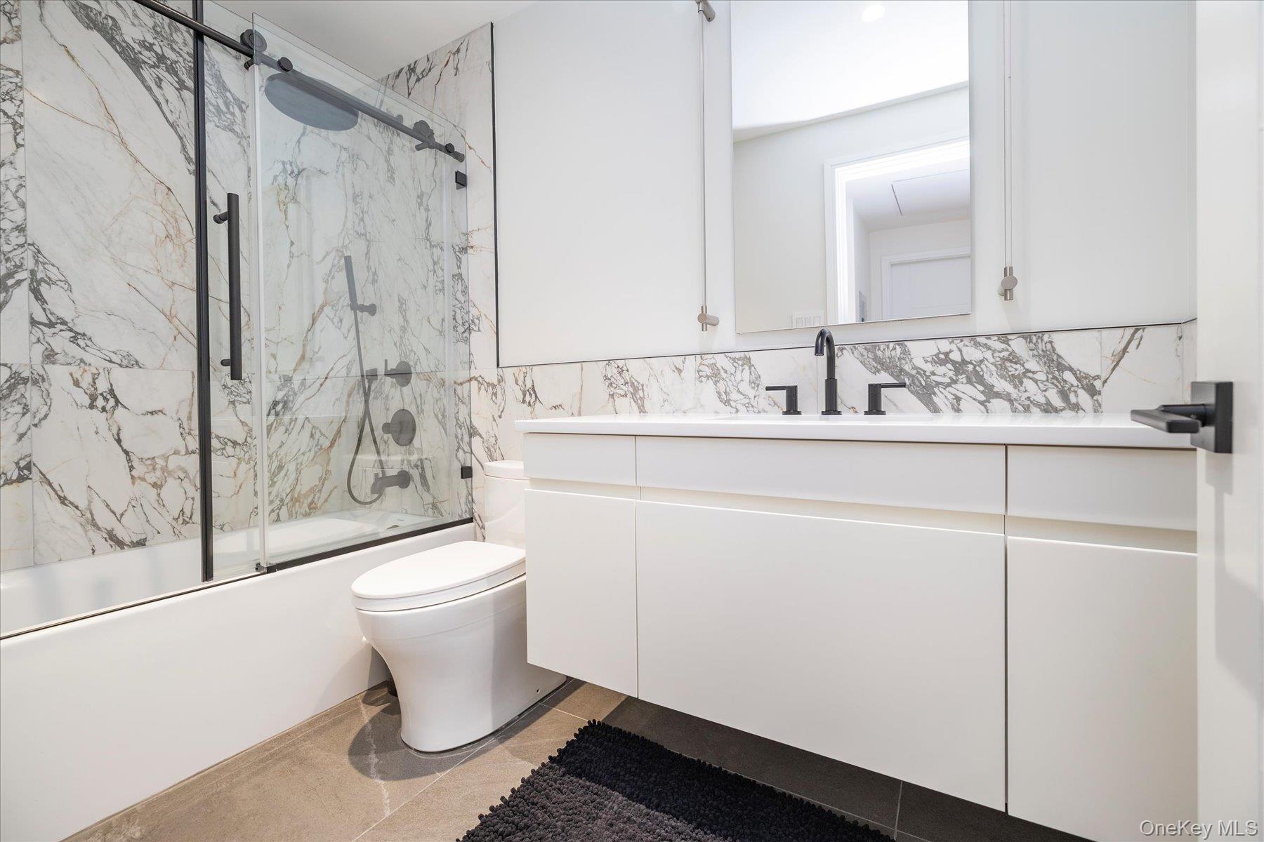 21 Dunhill Road New Hyde Park, NY 11040 - Photo 10 of 20 a bathroom with a sink toilet and shower
