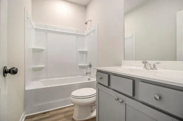 a bathroom with a sink toilet and a mirror