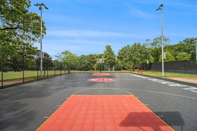 a view of a playground with basketball court