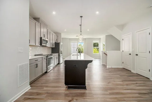 a view of kitchen with sink microwave and stove