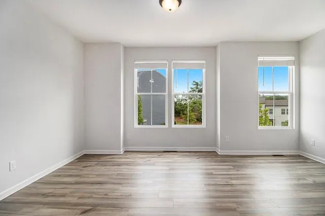 a view of wooden floor and windows in a room