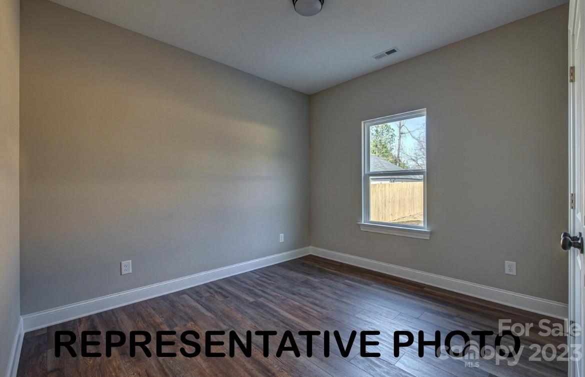 529 Blacksnake Road Stanley, NC 28164 - Photo 4 of 16 an empty room with wooden floor