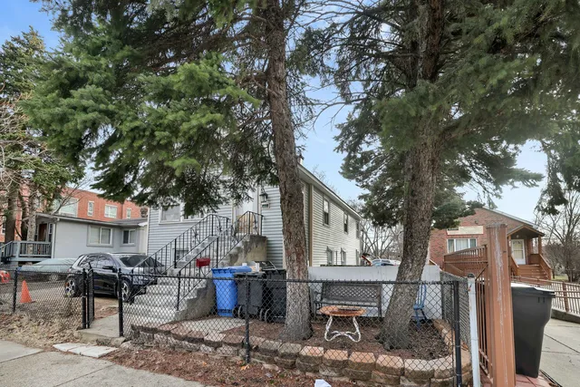 a backyard of a house with barbeque oven and outdoor seating