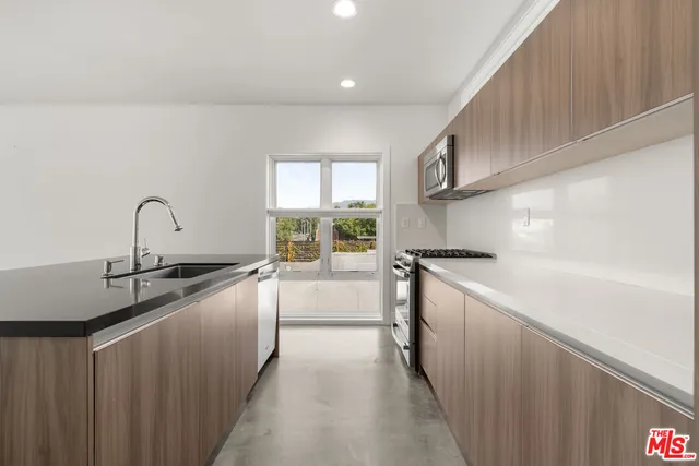 a kitchen with stainless steel appliances a sink and a stove