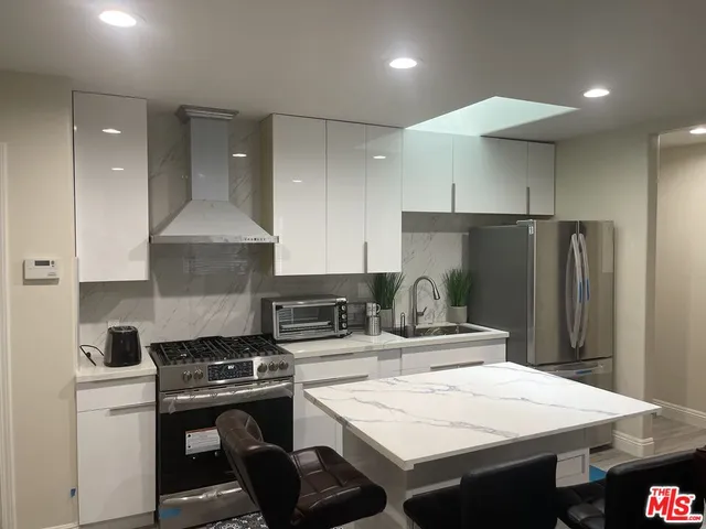 a kitchen with a stove a refrigerator and a stove