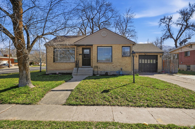 790 North 200 West Logan, UT 84321 - Photo 1 of 1 View of front of house featuring brick siding, an attached garage, and driveway