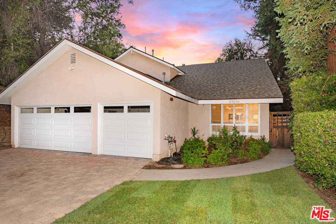 23030 Humming Bird Way Calabasas, CA 91302 - Photo 2 of 32 a view of a white house with a yard and potted plants