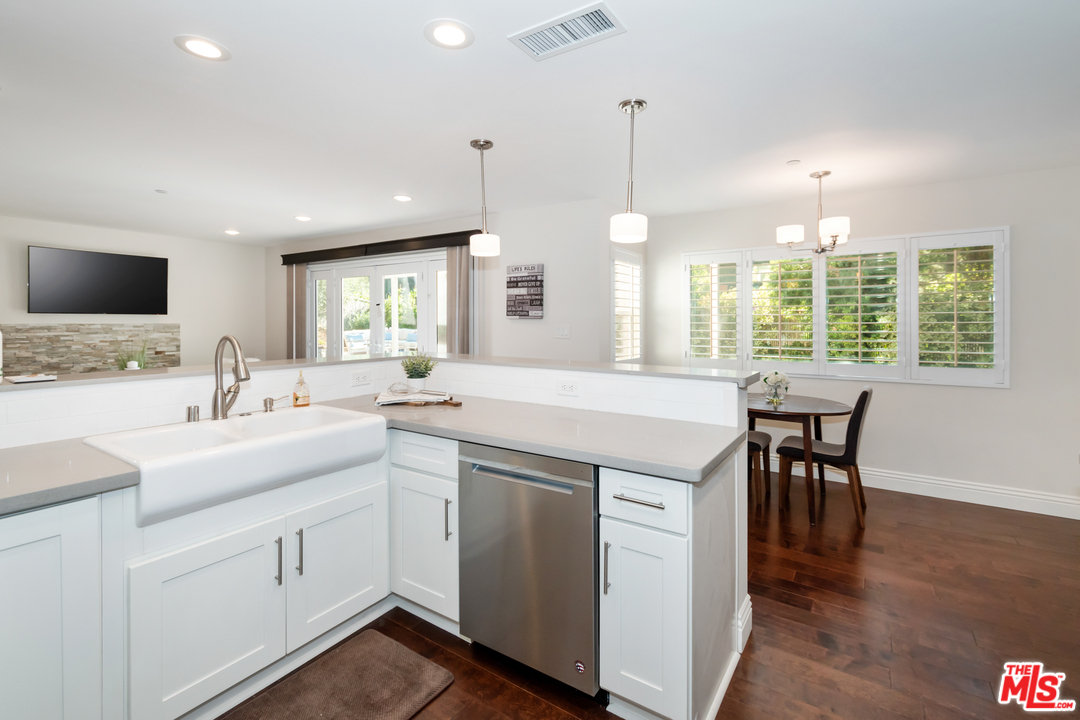 23030 Humming Bird Way Calabasas, CA 91302 - Photo 11 of 32 a kitchen with a sink stove and cabinets