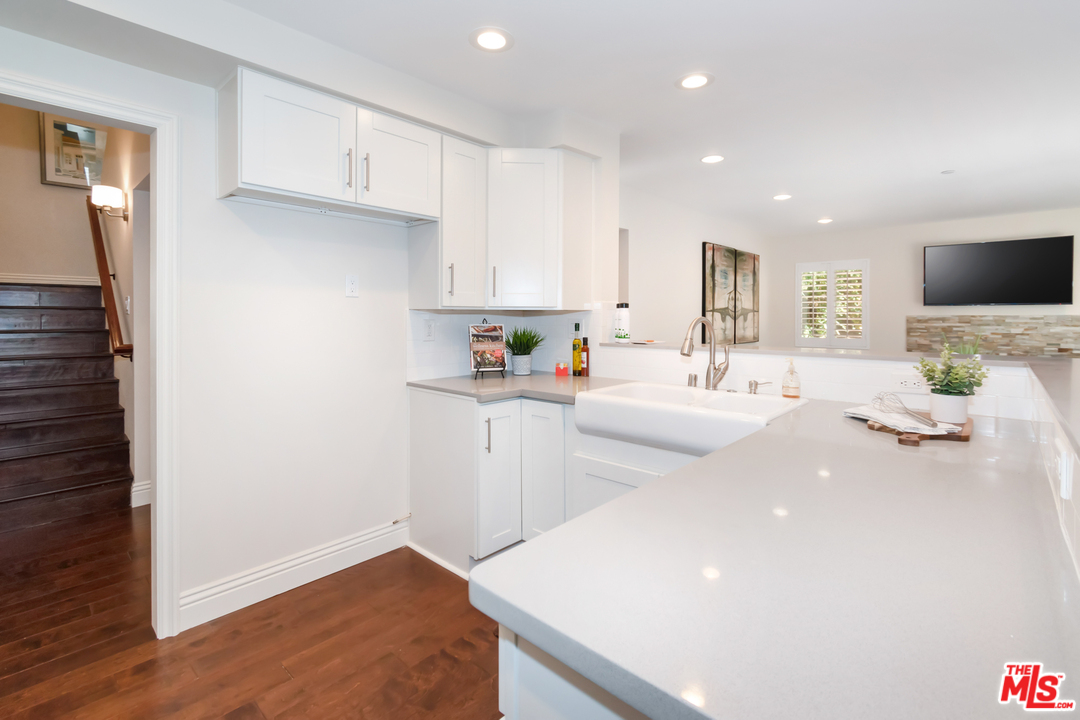 23030 Humming Bird Way Calabasas, CA 91302 - Photo 12 of 32 a kitchen with a sink a stove and cabinets