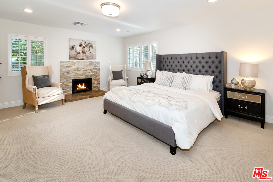 23030 Humming Bird Way Calabasas, CA 91302 - Photo 17 of 32 a spacious bedroom with a bed and a couch