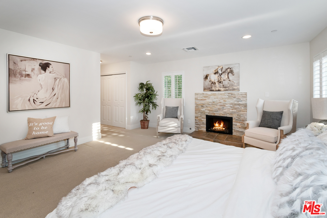 23030 Humming Bird Way Calabasas, CA 91302 - Photo 18 of 32 a bedroom with furniture and a fireplace