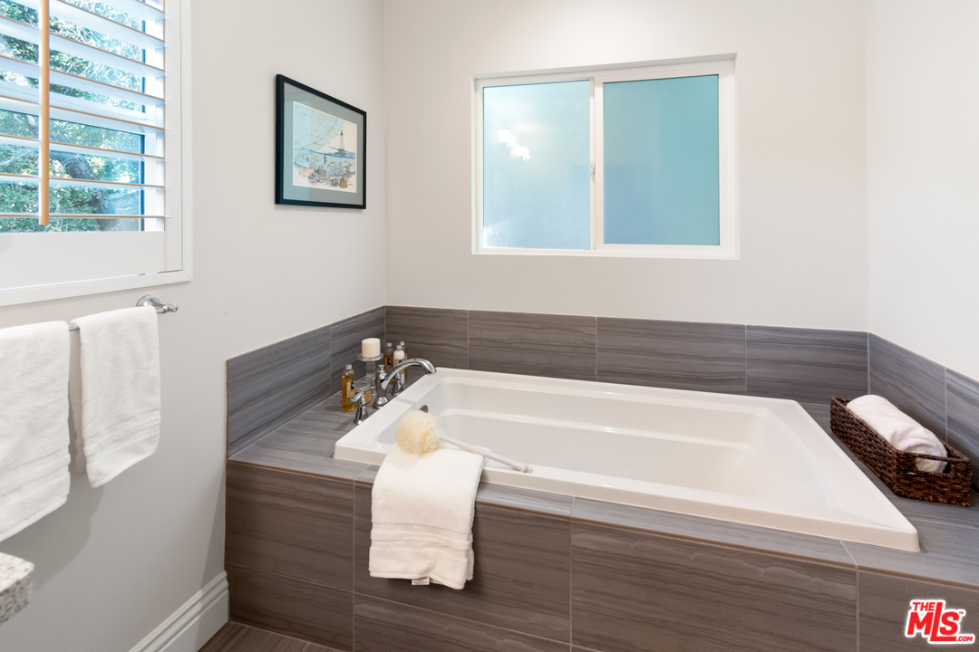 23030 Humming Bird Way Calabasas, CA 91302 - Photo 21 of 32 a bathroom with a bathtub and a window