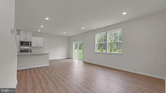 a view of kitchen with wooden floor and electronic appliances