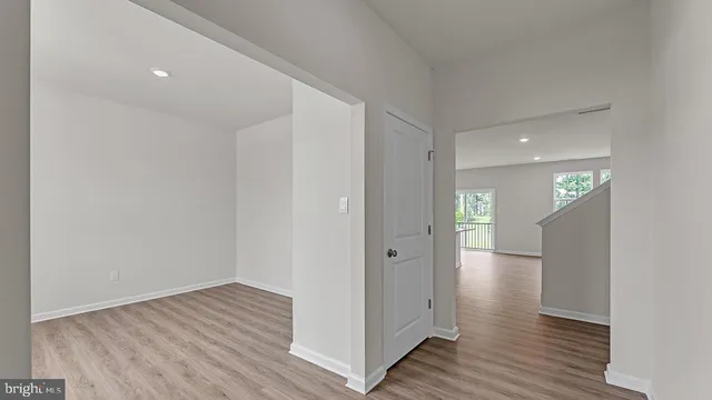 a view of hallway with wooden floor