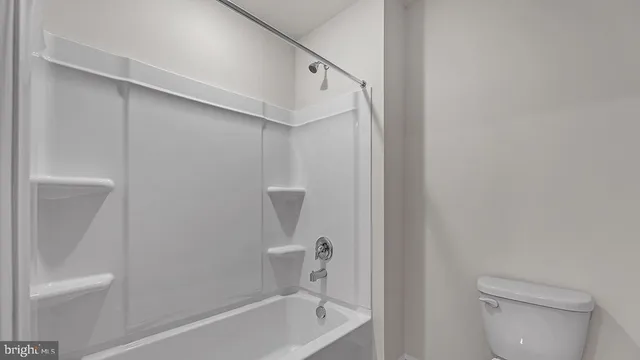 a bathroom with a bathtub a toilet and a shower