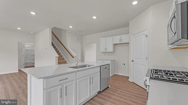 a kitchen with stainless steel appliances granite countertop a refrigerator and a sink