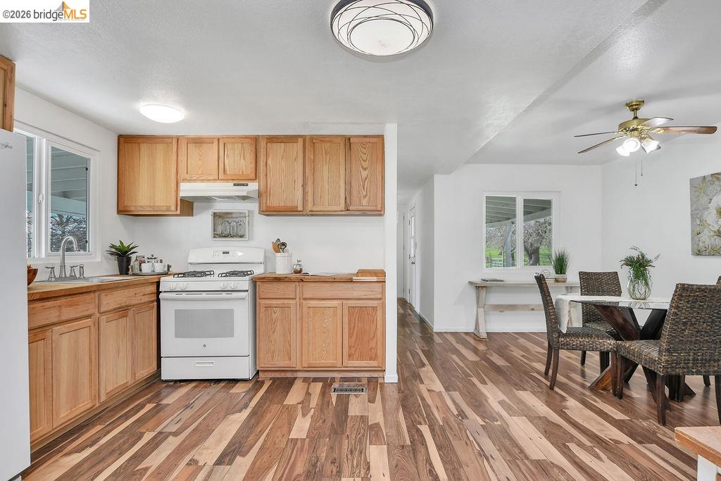 7550 Adams Road Valley Springs, CA 95252 - Photo 11 of 38 Kitchen featuring white appliances, dark wood finished floors, and ceiling fan