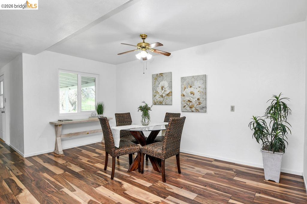 7550 Adams Road Valley Springs, CA 95252 - Photo 14 of 38 Dining area with a ceiling fan and dark wood-style floors