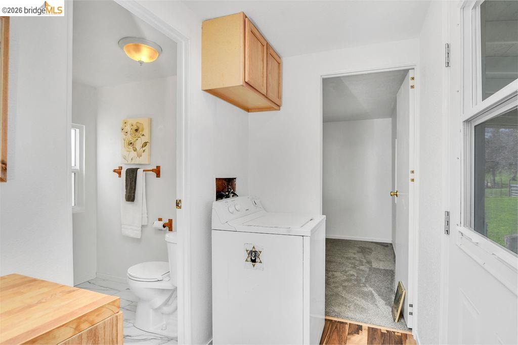 7550 Adams Road Valley Springs, CA 95252 - Photo 18 of 38 Half bath featuring washer / dryer and toilet