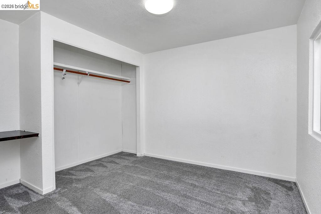7550 Adams Road Valley Springs, CA 95252 - Photo 20 of 38 Unfurnished bedroom featuring dark colored carpet and a closet