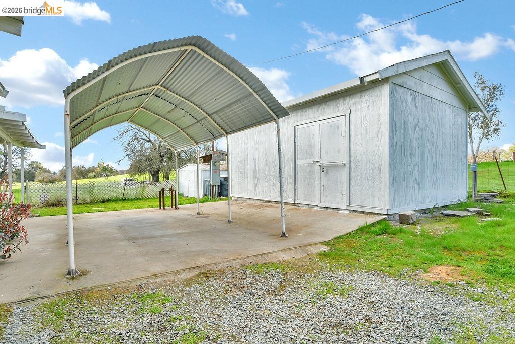 7550 Adams Road Valley Springs, CA 95252 - Photo 26 of 38 View of shed with a detached carport