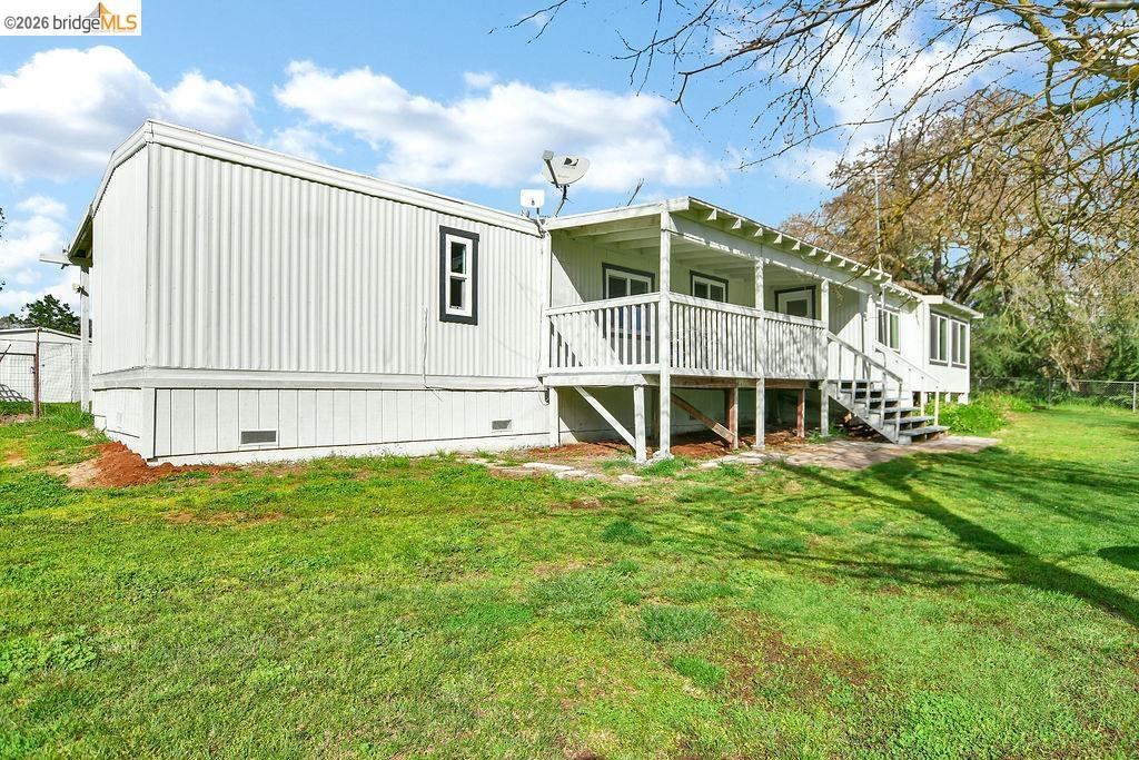 7550 Adams Road Valley Springs, CA 95252 - Photo 30 of 38 Rear view of house with crawl space and a yard