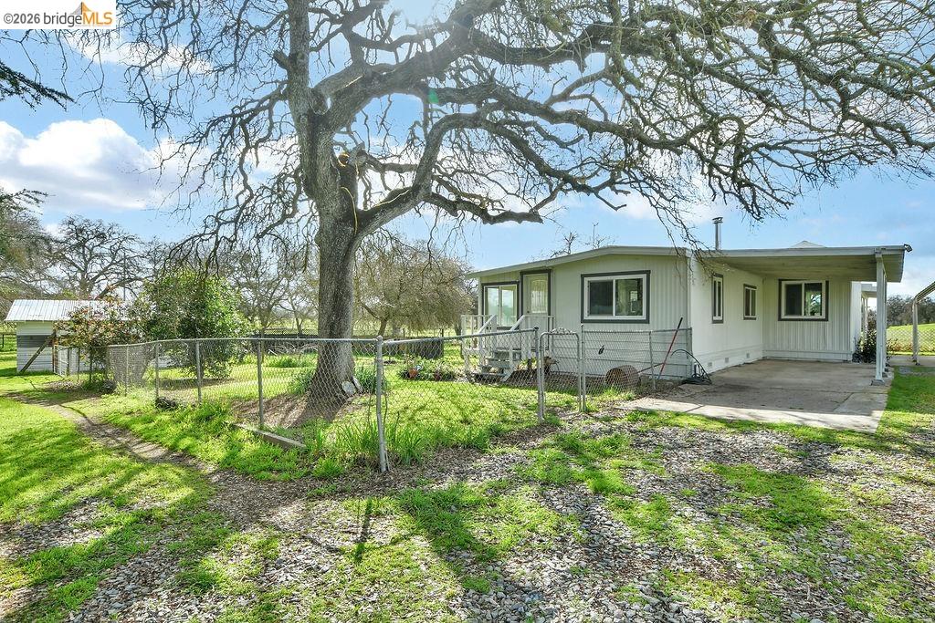 7550 Adams Road Valley Springs, CA 95252 - Photo 5 of 38 View of property exterior featuring a carport