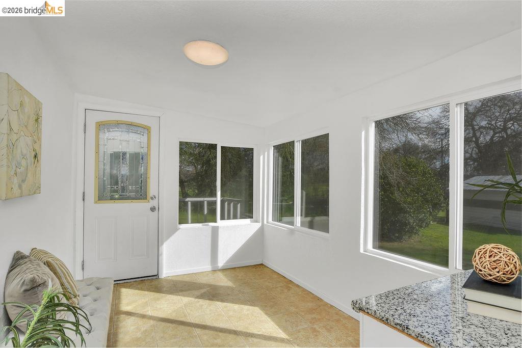 7550 Adams Road Valley Springs, CA 95252 - Photo 8 of 38 Unfurnished sunroom with baseboards