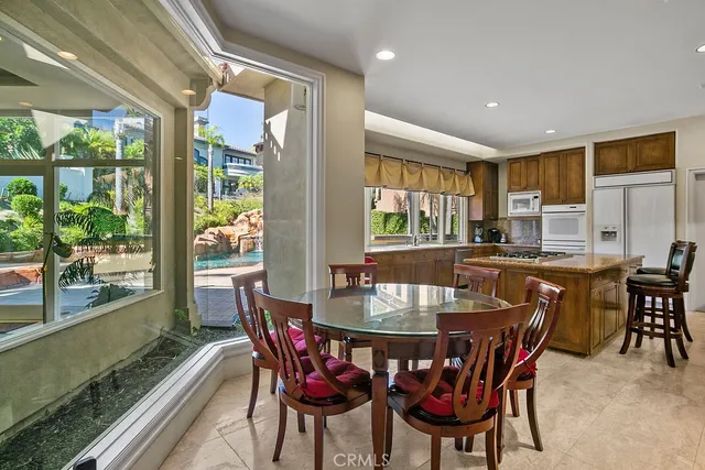 a dining room with furniture a rug and a floor to ceiling window
