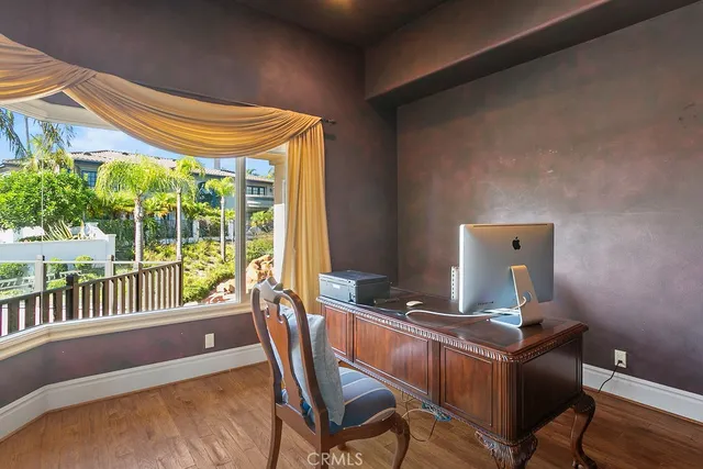 a view of a workspace with furniture and a window