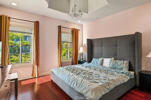 a bedroom with a large bed and a large window