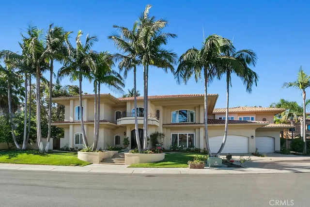 a front view of a house with garden and patio