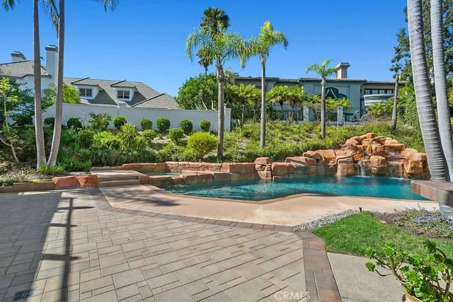 a view of a garden with a chair and potted plants