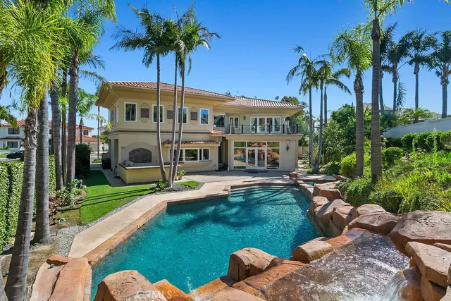 a view of a house with a yard and swimming pool