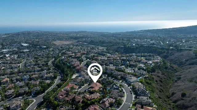 an aerial view of a house with a street
