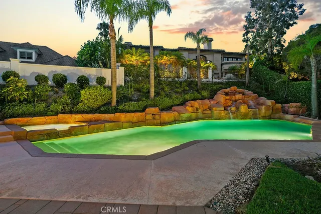 front view of a house with a yard and potted plants