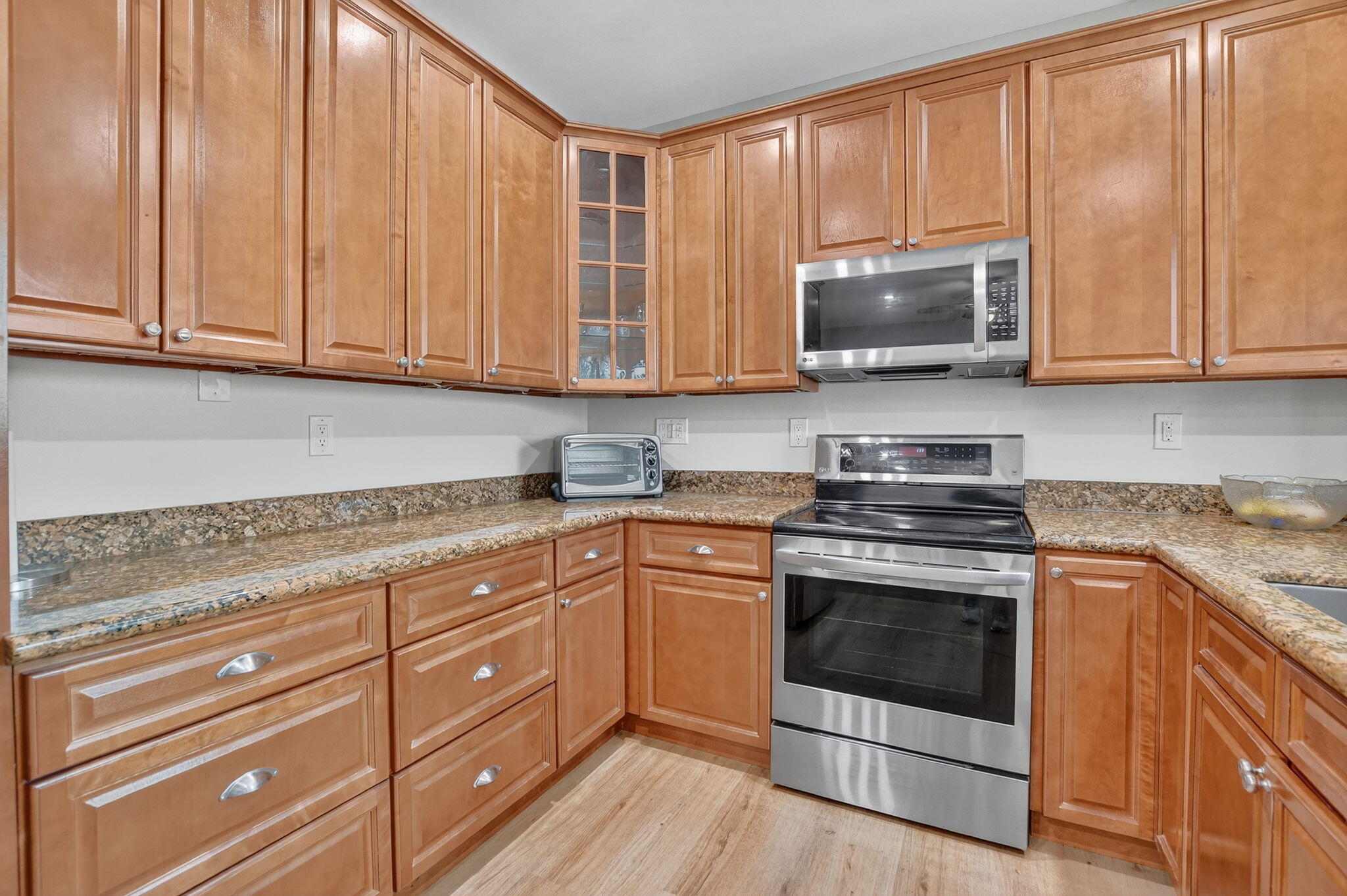 5908 Catesby Street Boca Raton, FL 33433 - Photo 11 of 49 a kitchen with granite countertop cabinets stainless steel appliances and wooden floor