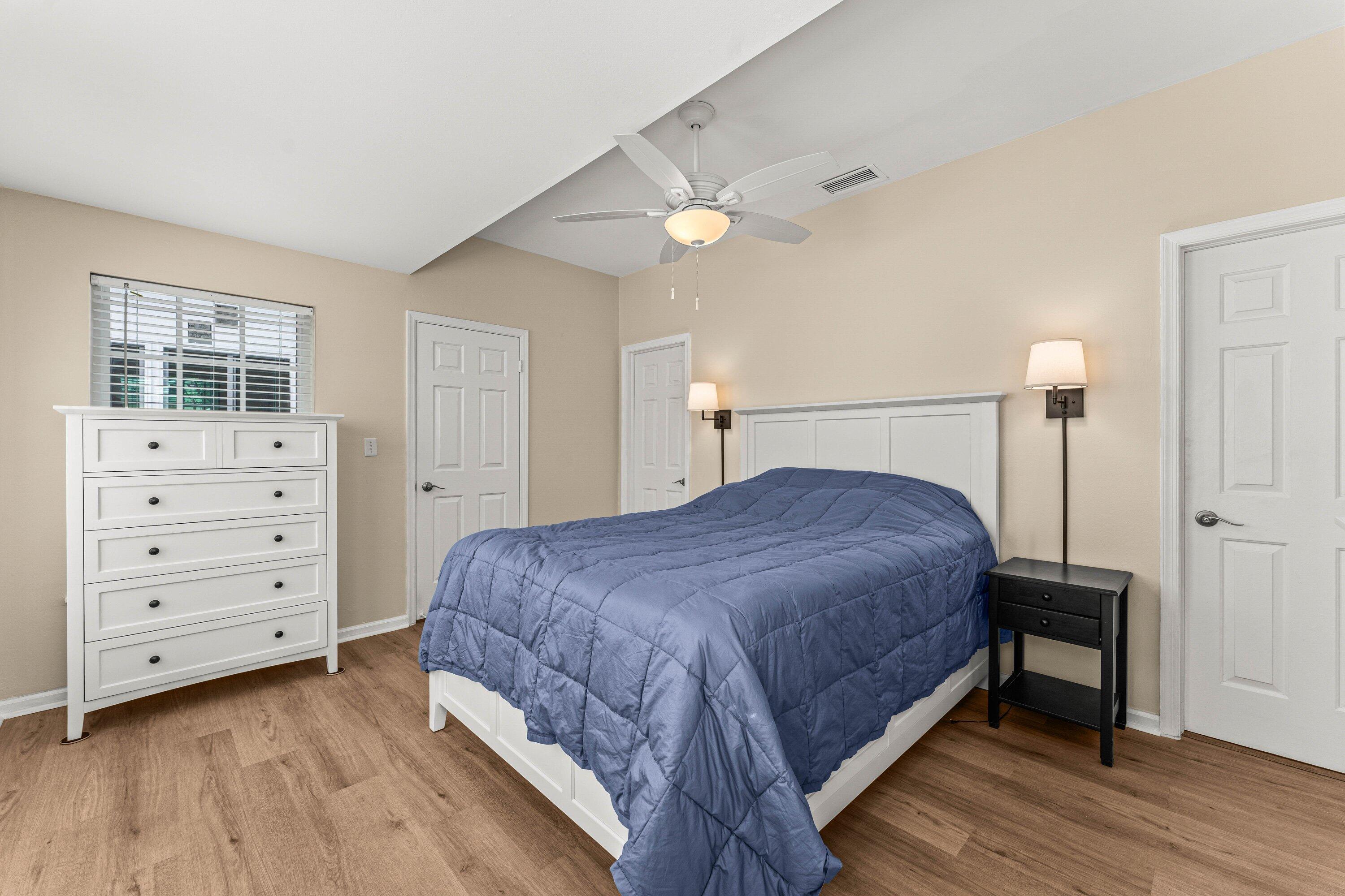 5908 Catesby Street Boca Raton, FL 33433 - Photo 16 of 49 a spacious bedroom with a bed a dresser and wooden floor