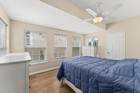 a bedroom with a large bed chandelier and a window