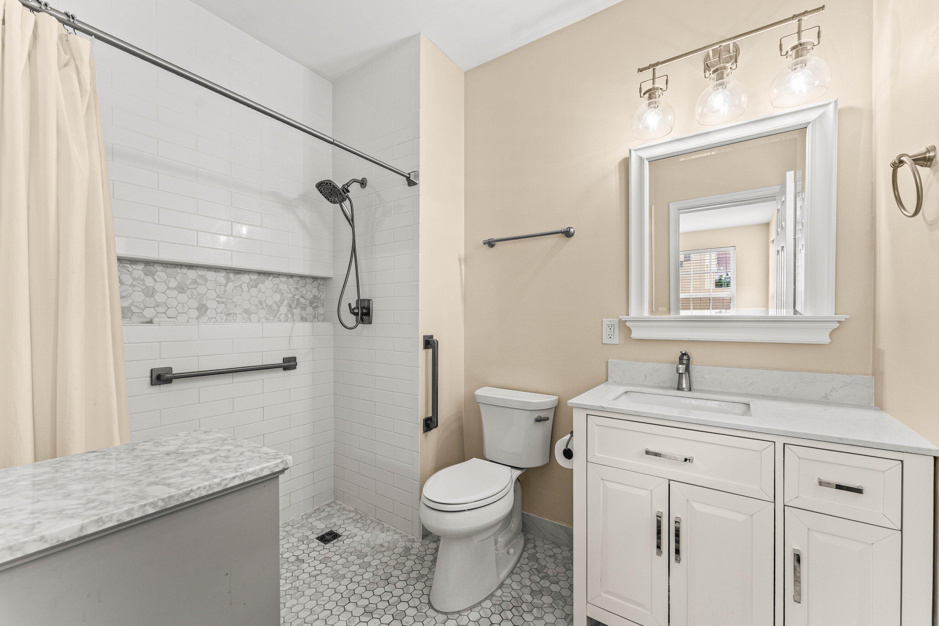 5908 Catesby Street Boca Raton, FL 33433 - Photo 18 of 49 a bathroom with a granite countertop sink toilet a mirror and shower
