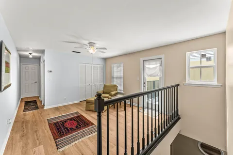 a view of a hallway with windows and stairs