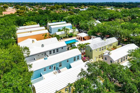 an aerial view of residential house with outdoor space and trees all around