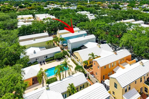 an aerial view of a house with large trees