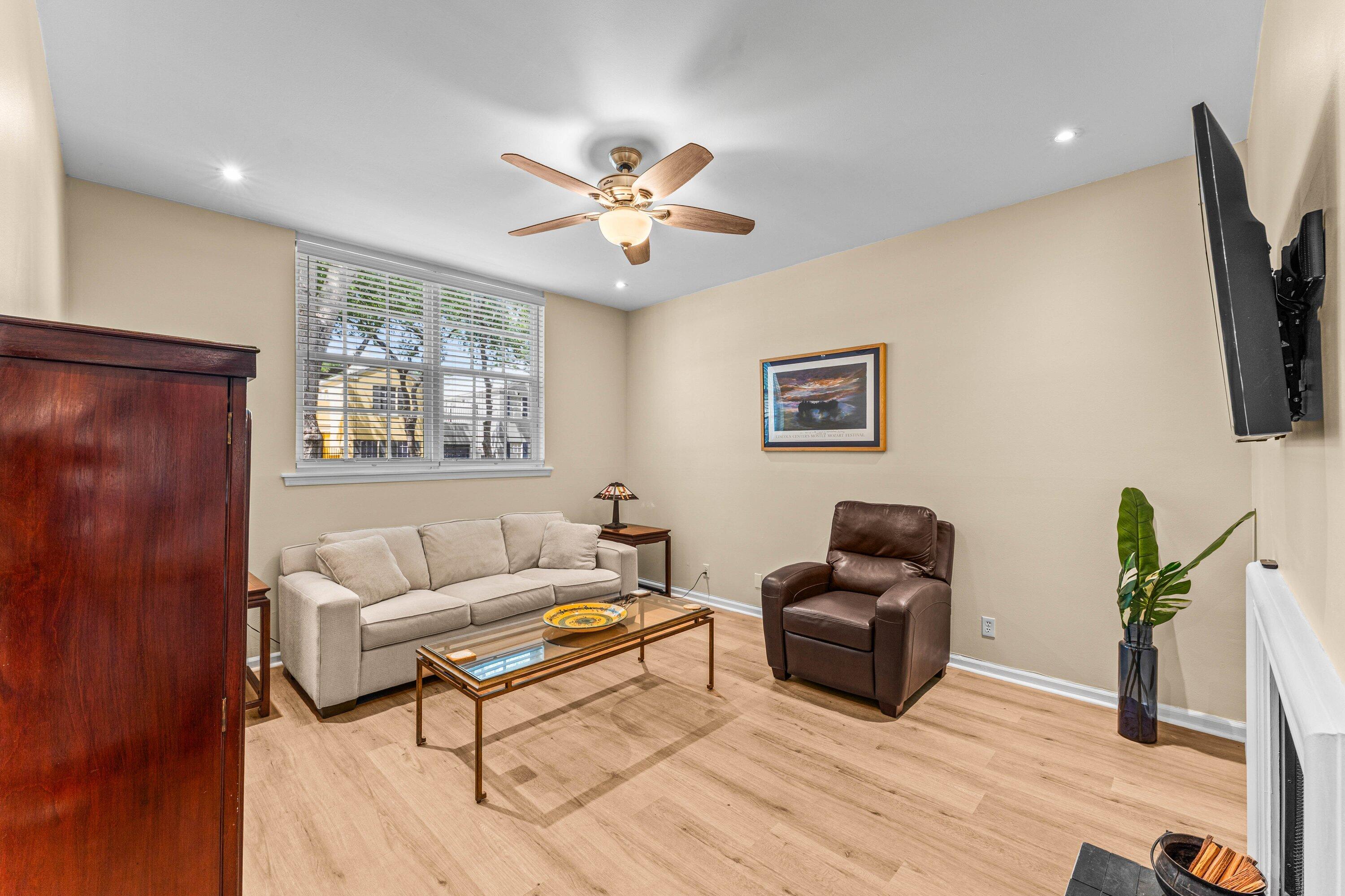 5908 Catesby Street Boca Raton, FL 33433 - Photo 8 of 49 a living room with furniture a ceiling fan a flat screen tv and a window