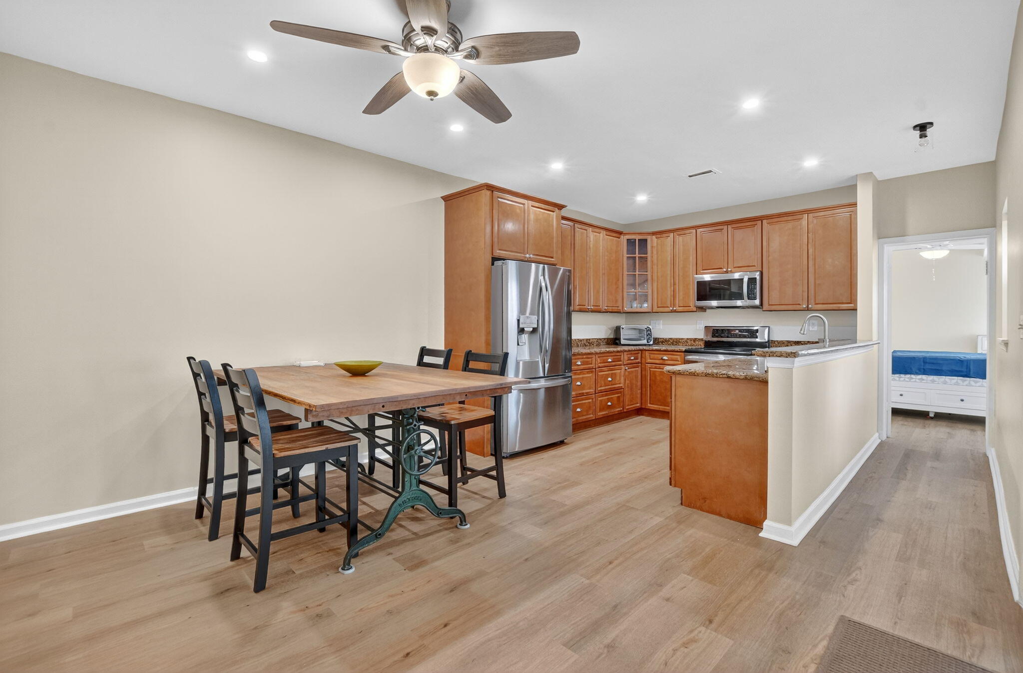 5908 Catesby Street Boca Raton, FL 33433 - Photo 10 of 49 a kitchen with stainless steel appliances kitchen island granite countertop a table chairs and a refrigerator