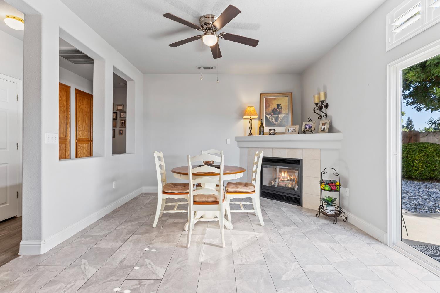 3300 Spring Garden Drive Turlock, CA 95382 - Photo 11 of 34 a living room with furniture a fireplace and a window