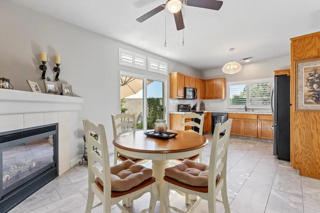 a kitchen with stainless steel appliances granite countertop a refrigerator a stove top oven and a sink