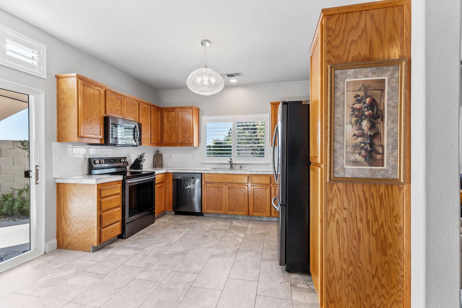 3300 Spring Garden Drive Turlock, CA 95382 - Photo 14 of 34 a kitchen with stainless steel appliances granite countertop a refrigerator and a stove top oven
