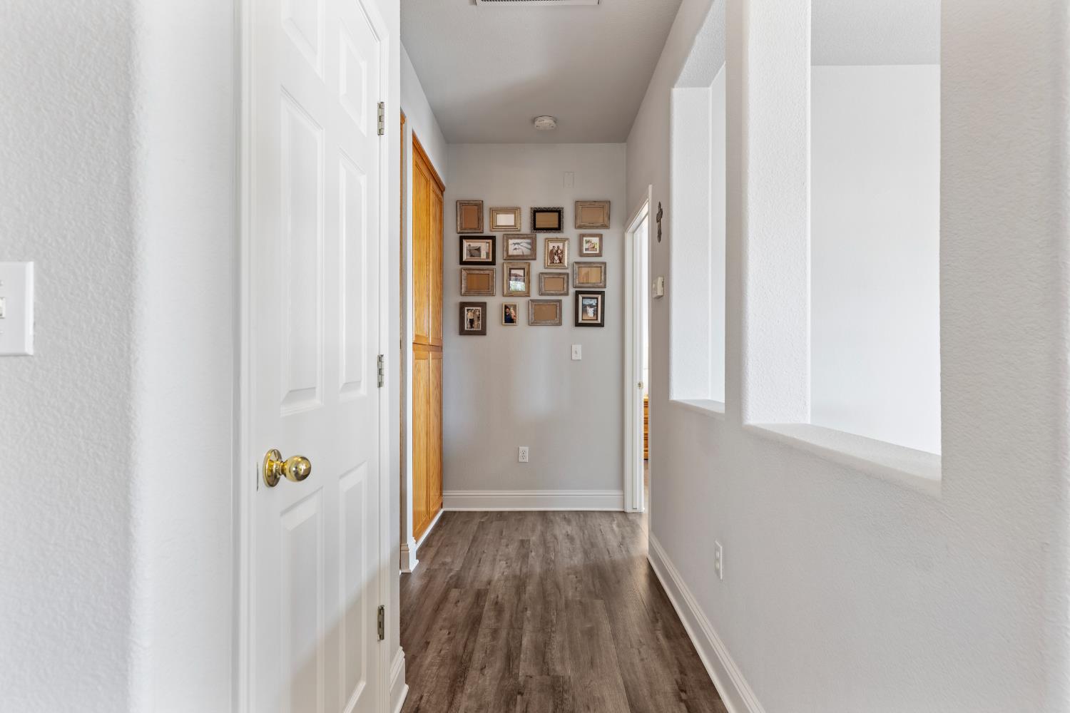 3300 Spring Garden Drive Turlock, CA 95382 - Photo 20 of 34 a view of a hallway with wooden floor and entryway