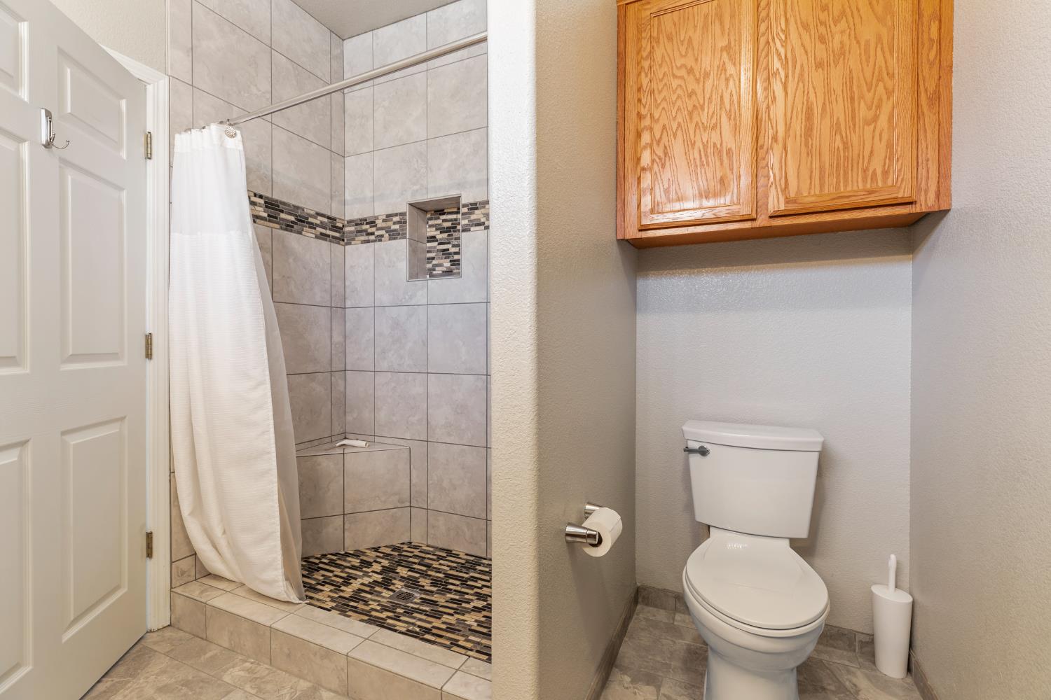 3300 Spring Garden Drive Turlock, CA 95382 - Photo 25 of 34 a bathroom with a toilet and a shower